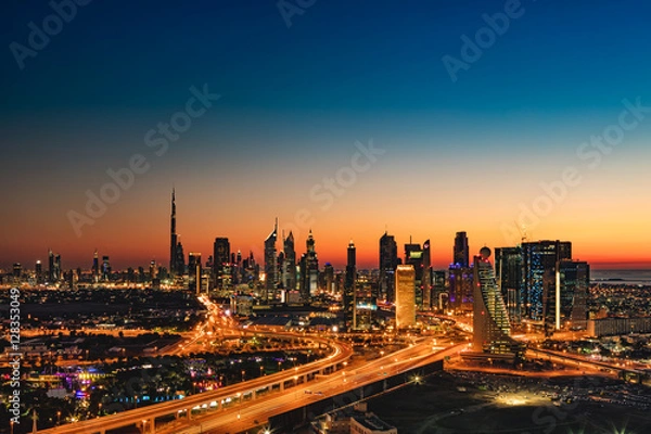 Fototapeta A beautiful Skyline view of Dubai, UAE as seen from Dubai Frame at sunset showing Burj Khalifa, Emirates Towers, Index Building, DIFC, World Trade Centre, H Hotel, Conrad and Etisalat Tower