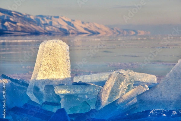 Fototapeta Broken ice on the background of mountains at dawn on Lake Baikal in winter