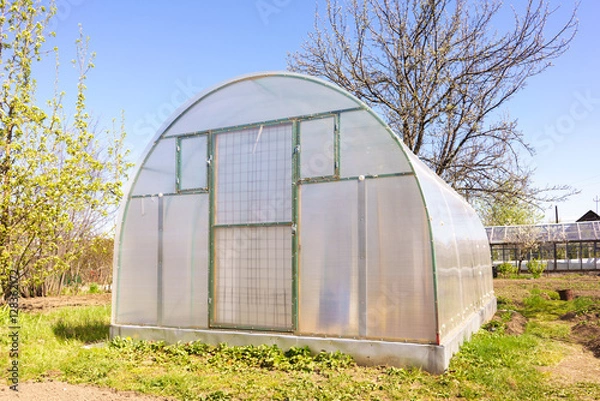 Fototapeta Modern Polycarbonate Greenhouse in Allotments for Growing Vegetables, Glasshouse Made of Polycarbonate, Farmland with Glasshouse, Plant Nursery, Sunlight Semicircle Hothouse, Self-sustaining