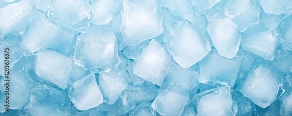 Fototapeta An assortment of blue ice cubes forms a textured background providing a visually appealing surface for creative design applications