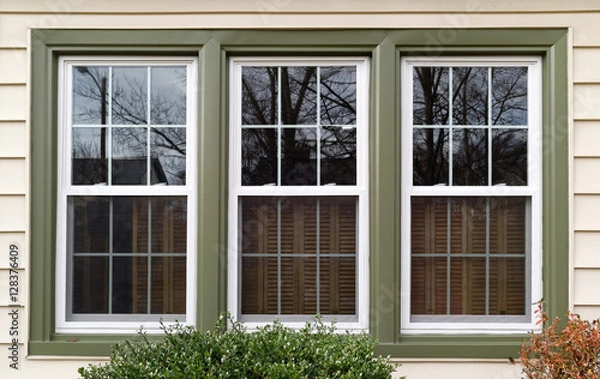 Obraz New white with green trim vinyl replacement windows. Horizontal.