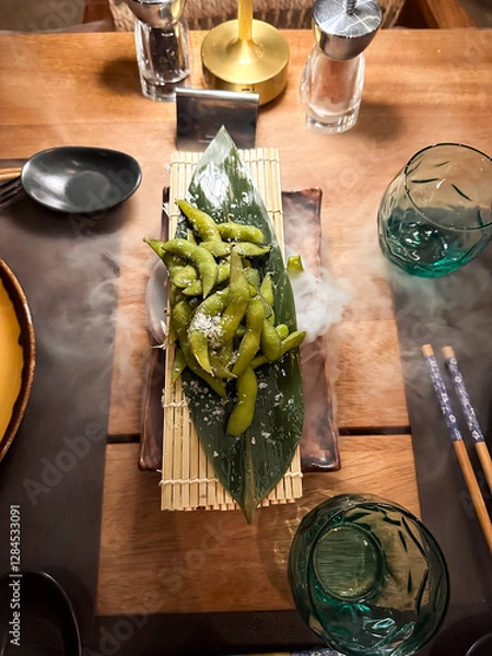 Fototapeta beautiful table setting for with a fog a dinner with vegetables, edamame