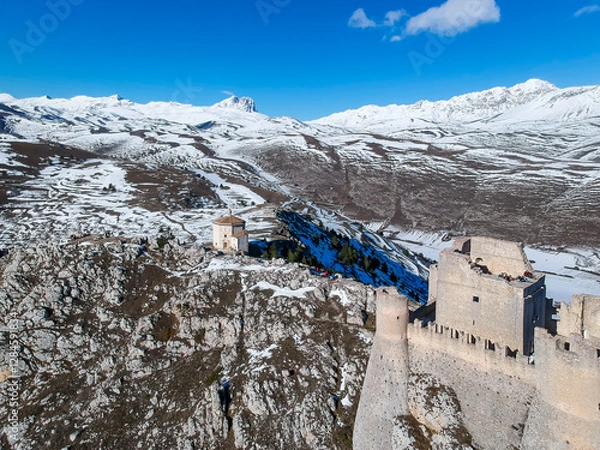 Fototapeta Drone view of the Castle of Rocca Calascio and the church of "Santa Maria della Pietà" on the mountain near to the municipality of Calascio, (L'Aquila, Abruzzo, Italy).