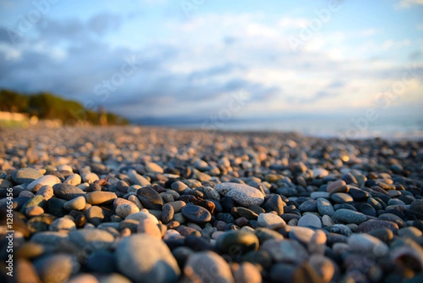 Fototapeta sunset on pebble beach