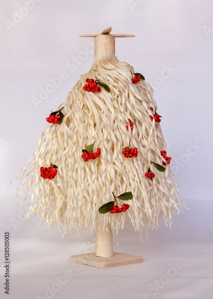 Obraz  Christmas tree made of wood shavings with red berries 