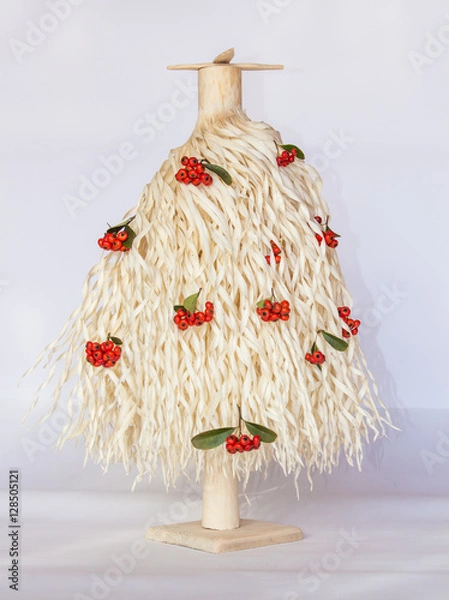 Obraz white Christmas tree made of wood shavings with red berries 