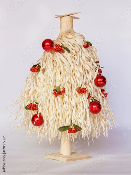Obraz white Christmas tree made of wood shavings with red and green ball ornaments 