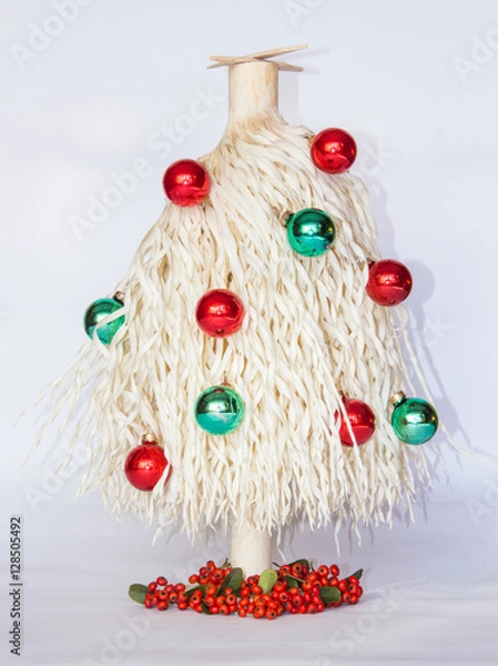 Obraz white Christmas tree made of wood shavings with red and green ball ornaments 