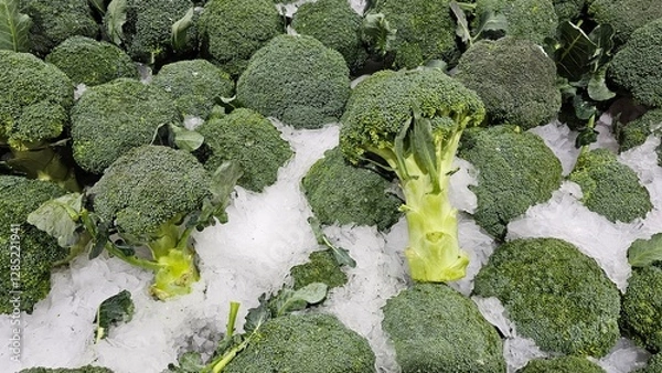 Fototapeta a pile of fresh broccoli displayed on ice