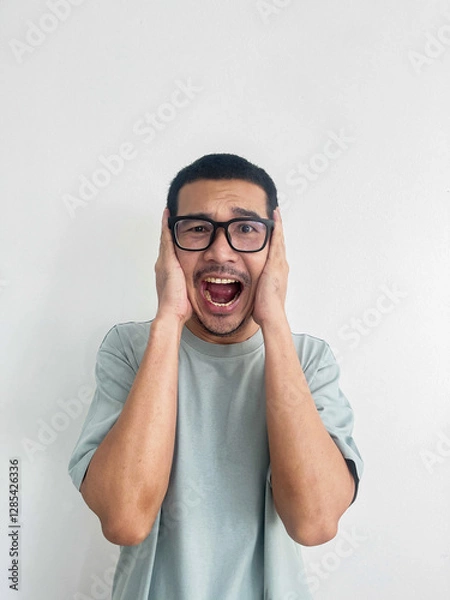 Fototapeta Asian man wearing glasses shocking, fear scared face ears close with hands half body isolated on white background