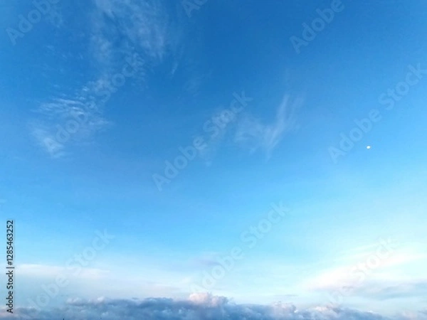 Fototapeta Blue sky with white clouds, a serene and
peaceful natural landscape perfect for
backgrounds and designs. Sunny daytime
setting.