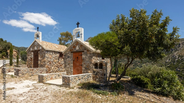 Fototapeta Two small colorful churches besides a mountain road at Kandanos-Selinos, Crete, Greece