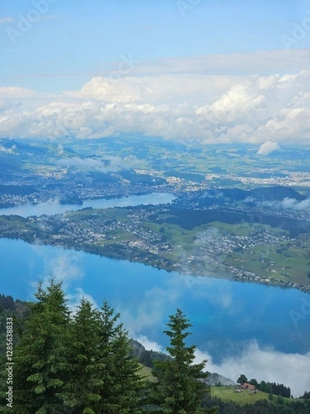 Fototapeta A stunning summer view from Mount Rigi, often referred to as the "Queen of the Mountains," offering panoramic vistas of the Swiss Alps and surrounding lakes. This image captures the lush green meadows