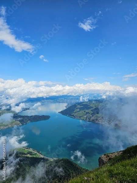 Fototapeta A stunning summer view from Mount Rigi, often referred to as the "Queen of the Mountains," offering panoramic vistas of the Swiss Alps and surrounding lakes. This image captures the lush green meadows