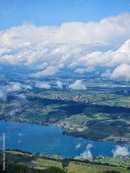 Fototapeta A stunning summer view from Mount Rigi, often referred to as the "Queen of the Mountains," offering panoramic vistas of the Swiss Alps and surrounding lakes. This image captures the lush green meadows