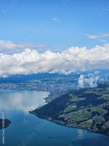 Fototapeta A stunning summer view from Mount Rigi, often referred to as the "Queen of the Mountains," offering panoramic vistas of the Swiss Alps and surrounding lakes. This image captures the lush green meadows