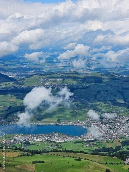 Fototapeta A stunning summer view from Mount Rigi, often referred to as the "Queen of the Mountains," offering panoramic vistas of the Swiss Alps and surrounding lakes. This image captures the lush green meadows