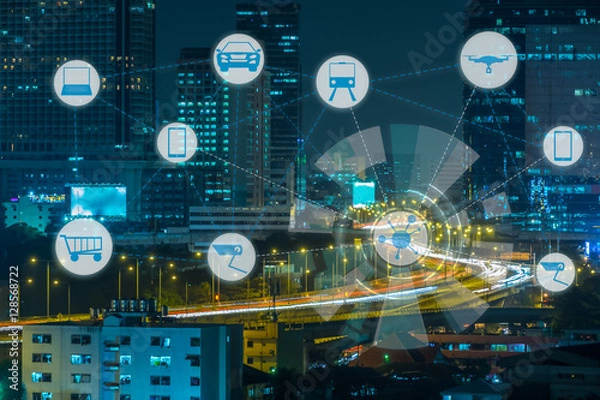 Fototapeta Internet of Things and Smart city concept. Smart things icons mesh on city traffic night background.