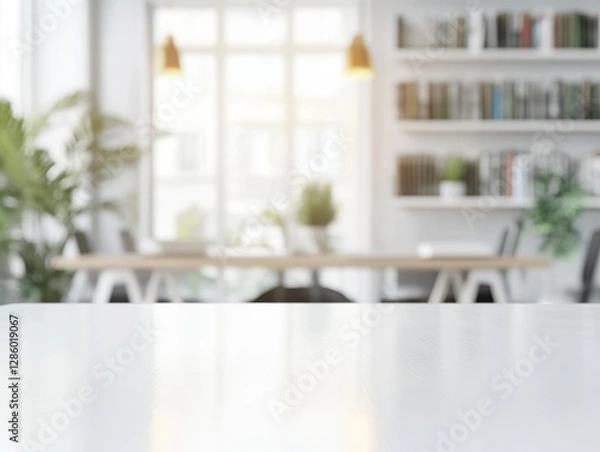 Obraz Sleek white rectangular wooden table with soft lighting and blurred stylish office background featuring books and plants
