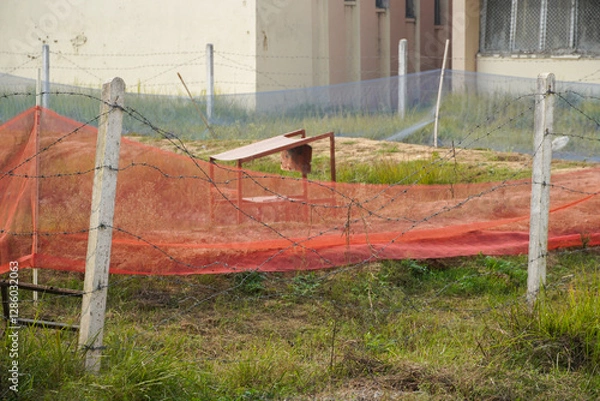Obraz Abandoned Area with Barbed Wire and Red Net