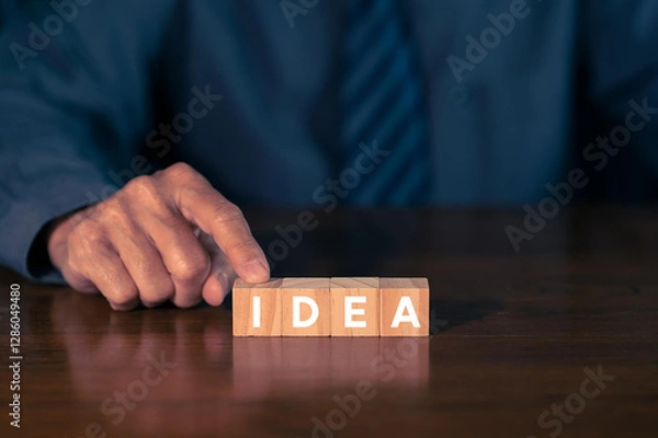 Fototapeta Idea on wood block with businessman hand touching Business concept
