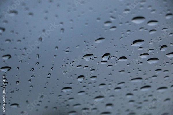 Fototapeta close-up of isolated raindrops on a window pane