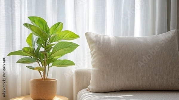 Obraz A vibrant plant rests on a table beside a cozy couch, enhancing the living space with its natural beauty and inviting atmosphere.