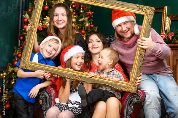Obraz big happiness smiling family house in santa helper hats