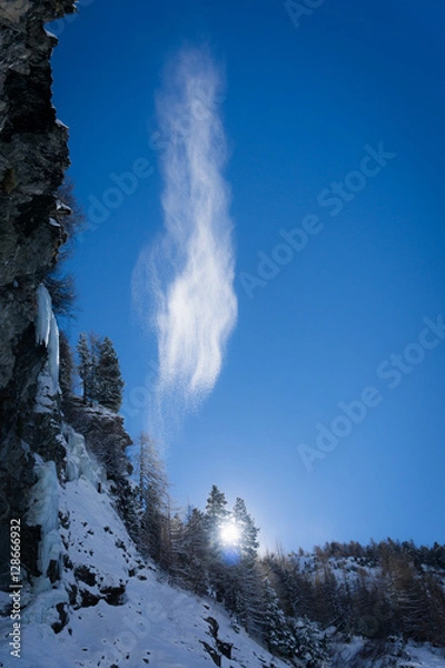 Fototapeta snow falling in the mountains