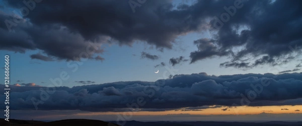 Obraz Crescent moon rising above storm clouds at dawn, celestial wonder