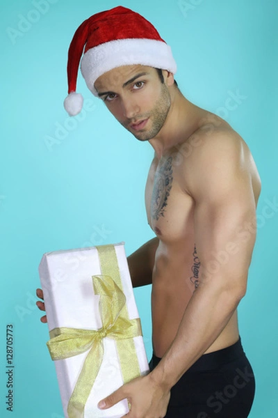 Fototapeta Père Noël sexy tenant un cadeau