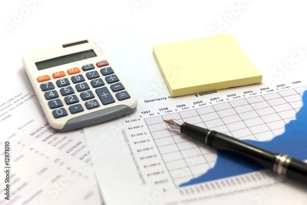Fototapeta Business reports with calculator and fountain pen.