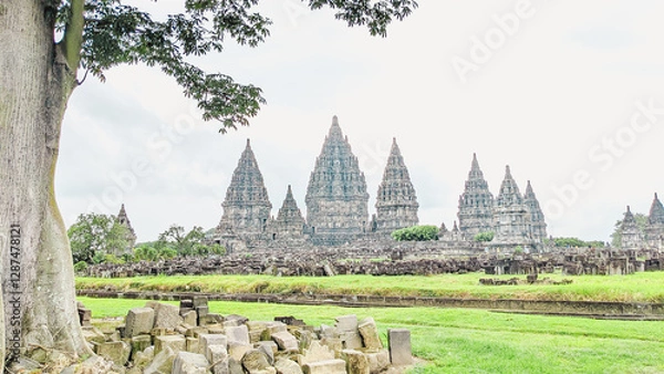 Obraz Straight angle view. the Prambanan temple, Central Java, Indonesia with Scattered solid masonry and a majestic trees