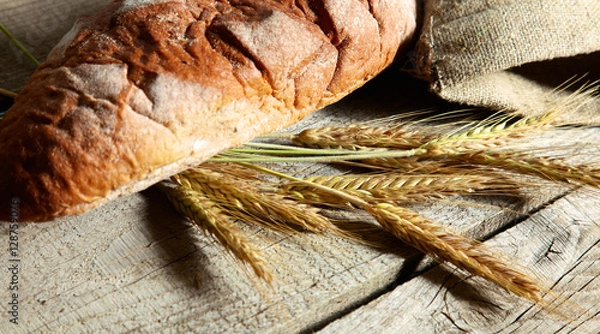 Fototapeta bread and ears are on the old table