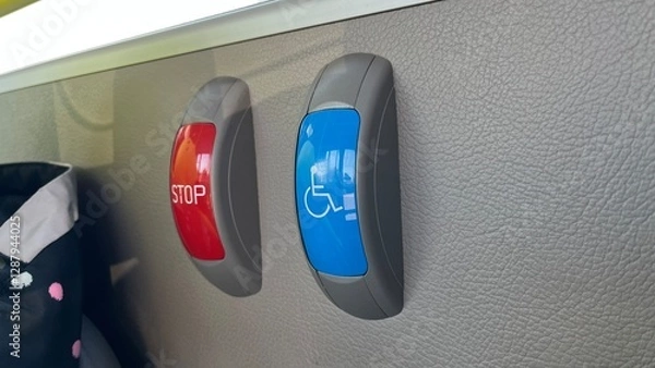 Fototapeta Bus stop request buttons. Red "STOP" and blue accessibility symbol on a bus interior wall