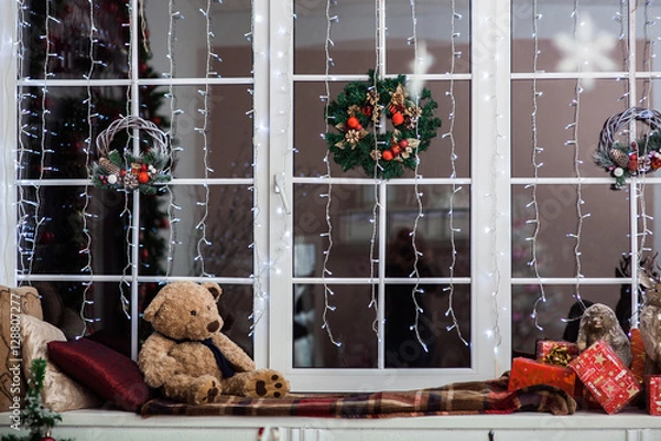 Obraz Holiday decoration on the windowsill covered with woolen plaid. Christmas wreath, 