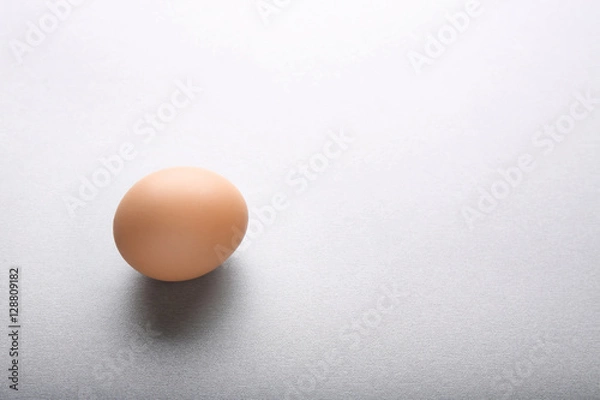 Fototapeta Raw egg on grey background