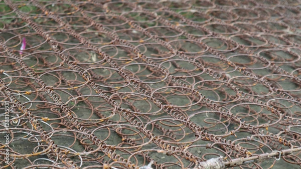 Fototapeta Rusty metal bedspring with intricate coil patterns