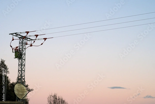 Fototapeta Small electric tower in hydroelectric power station with light background with cables crossing horizontally