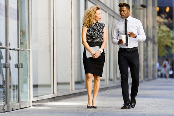 Obraz Business colleeagues walking along the office building