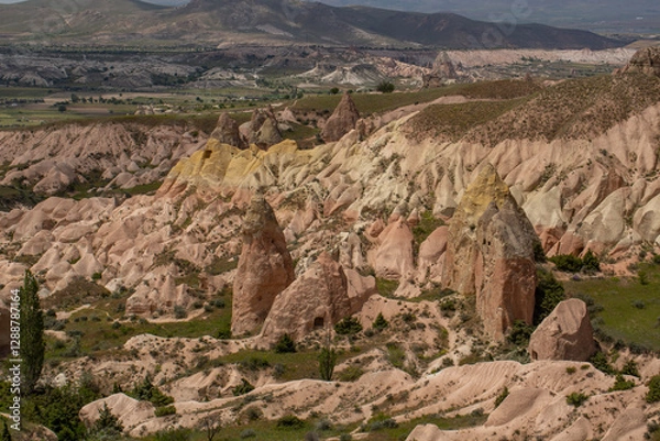 Fototapeta Cappadocia’s colorful rock formations, shaped by wind and water erosion, create a surreal landscape. Layers of volcanic rock reveal history, while valleys and cliffs form an awe-inspiring natural wond