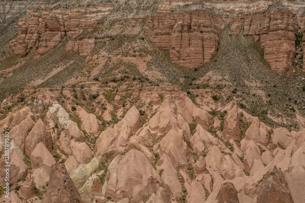 Fototapeta Cappadocia’s colorful rock formations, shaped by wind and water erosion, create a surreal landscape. Layers of volcanic rock reveal history, while valleys and cliffs form an awe-inspiring natural wond