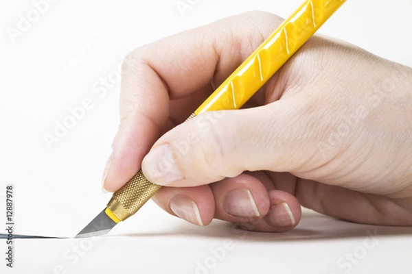 Fototapeta Hand with cutter