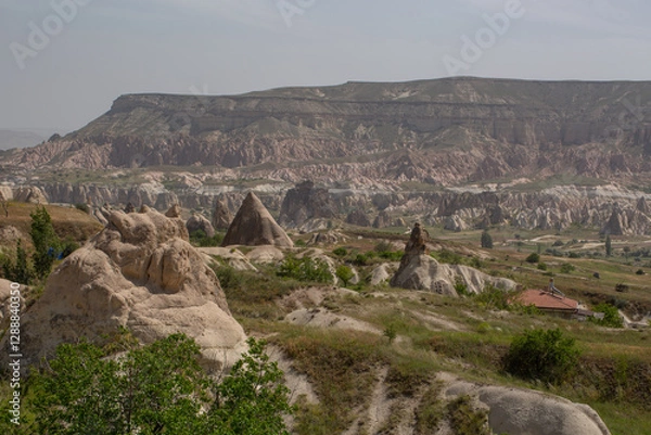 Fototapeta Cappadocia’s colorful rock formations, shaped by wind and water erosion, create a surreal landscape. Layers of volcanic rock reveal history, while valleys and cliffs form an awe-inspiring natural wond