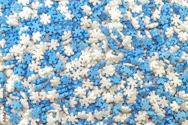 Fototapeta Tiny blue and white snowflake shaped baking sprinkles