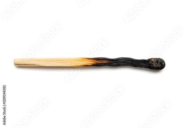 Fototapeta A scorched matchstick stands alone against a white background, its burnt tip showing signs of use. The image includes a clipping path for easy editing and integration