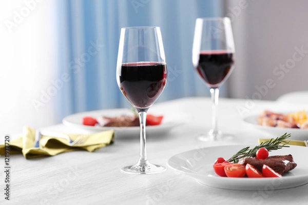 Fototapeta Steak and appetizers with wine on table