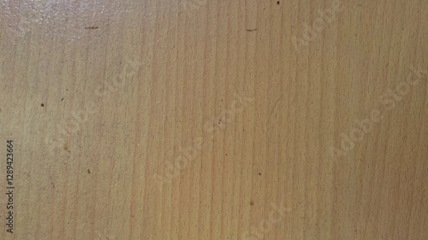 Fototapeta The wooden surface looks smooth and even. The wooden surface has a warm light brown color with a clearly visible wood grain pattern