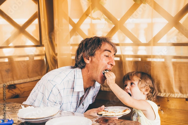 Obraz Child with father have a breakfast.