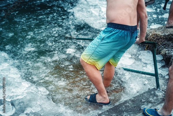 Obraz Winter swimming. Man in an ice-hole.